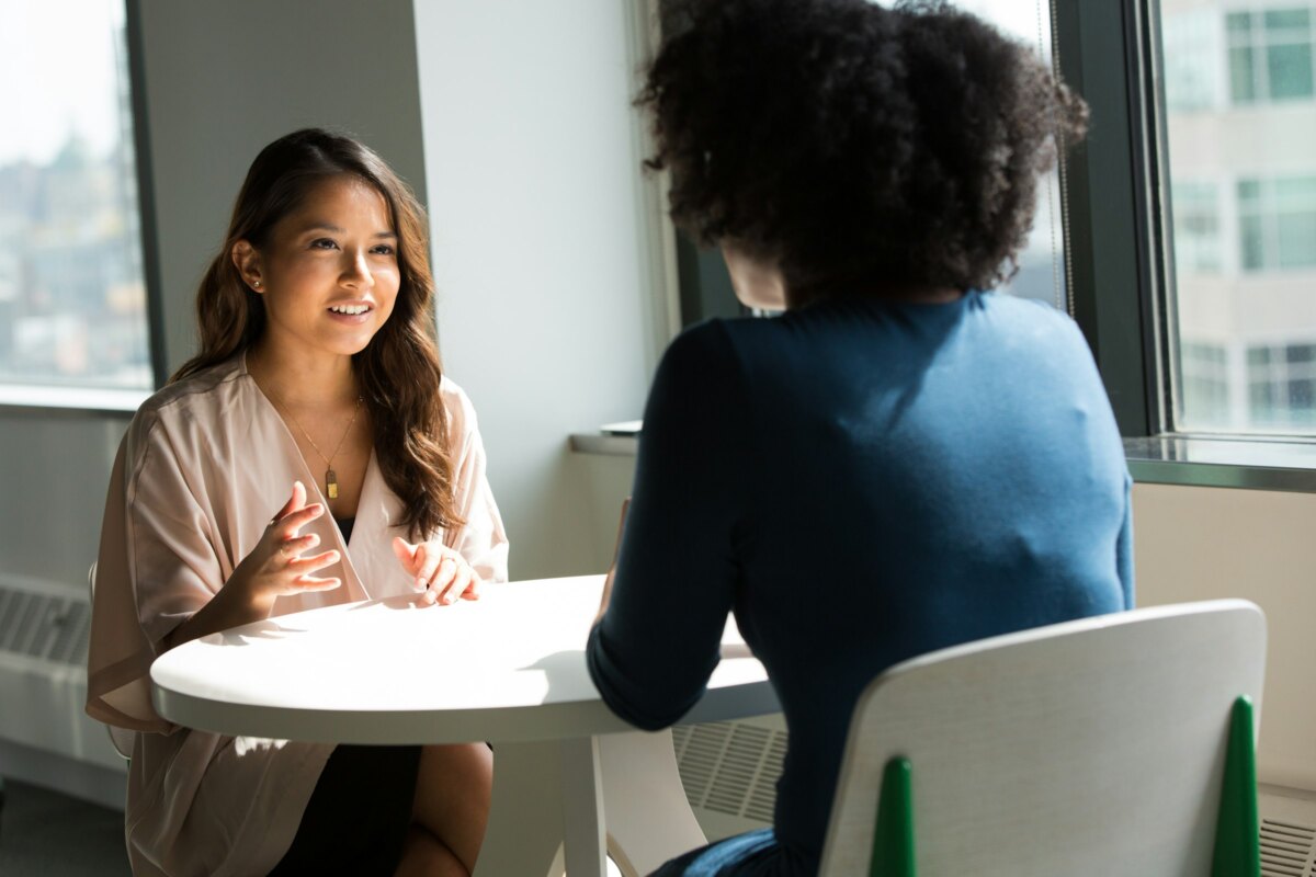 A one-to-one conversation at a table