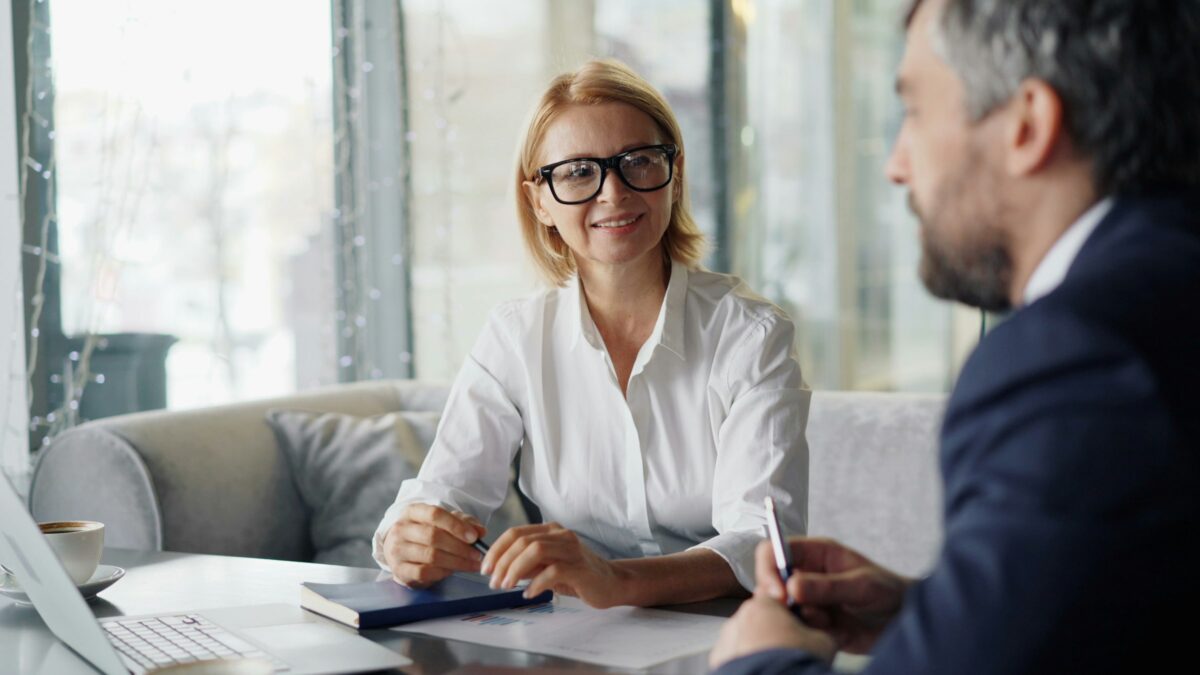 A woman meeting an adviser across a desk